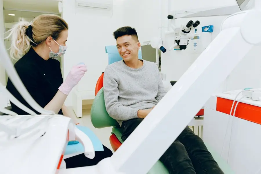 Dentist chatting with a smiling patient